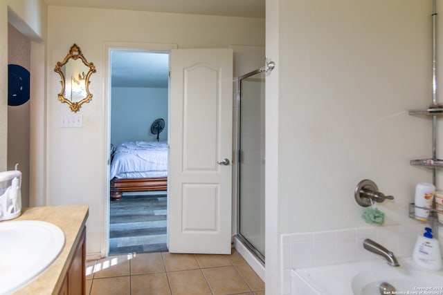 bathroom featuring tile flooring, an enclosed shower, and vanity