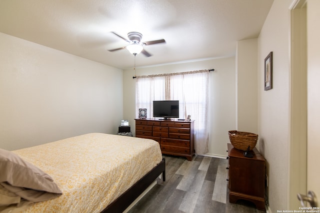 bedroom with ceiling fan and dark hardwood / wood-style flooring