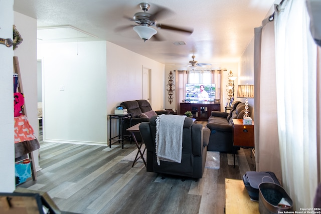 living room featuring dark hardwood / wood-style flooring and ceiling fan