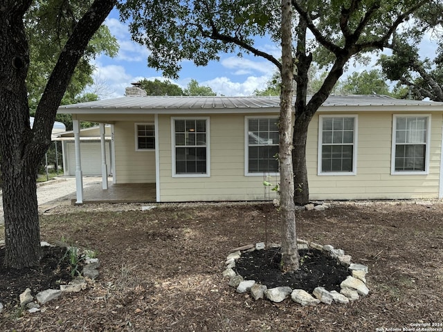 rear view of house with a garage