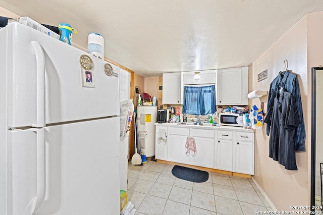 kitchen featuring white cabinets, white appliances, electric water heater, and sink