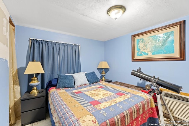 tiled bedroom with a textured ceiling