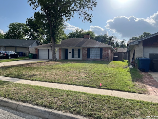 ranch-style home with a front lawn and a garage