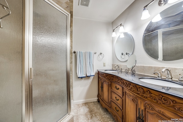 bathroom with an enclosed shower, tile patterned flooring, and double sink vanity