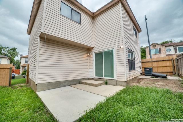 rear view of house with a patio and central AC