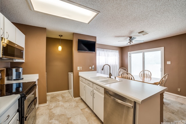 kitchen featuring appliances with stainless steel finishes, white cabinets, sink, light tile patterned flooring, and ceiling fan