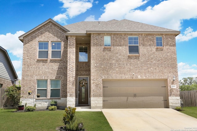 view of front of property featuring a garage and a front lawn