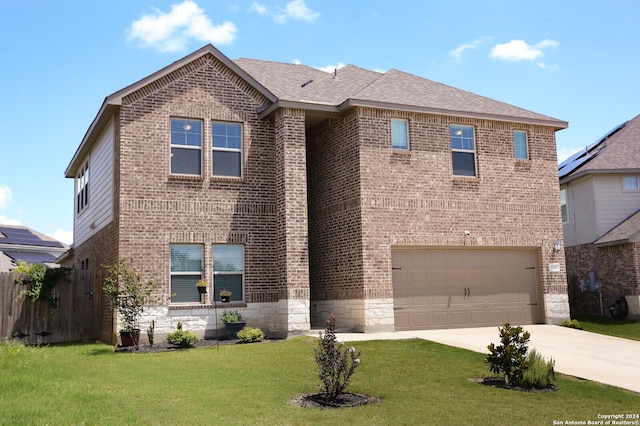 view of front facade with a garage and a front yard