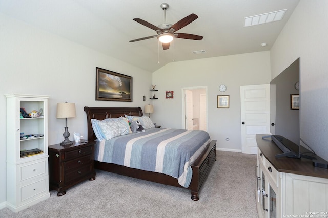 carpeted bedroom featuring lofted ceiling, ensuite bath, and ceiling fan