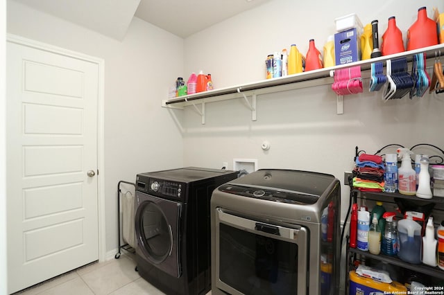 washroom with washer and dryer and light tile patterned flooring