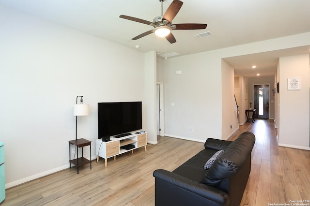 living room featuring ceiling fan and light hardwood / wood-style flooring