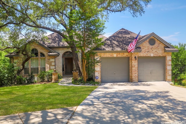 view of front of property featuring a garage and a front lawn