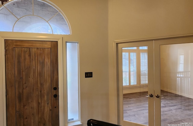 entryway featuring wood-type flooring and french doors