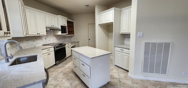 kitchen featuring white cabinetry, electric range, tasteful backsplash, a center island, and sink