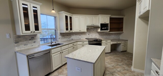 kitchen with appliances with stainless steel finishes, white cabinetry, decorative light fixtures, and tasteful backsplash