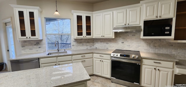 kitchen with appliances with stainless steel finishes, tasteful backsplash, sink, hanging light fixtures, and light tile patterned floors