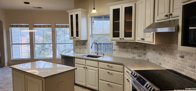 kitchen featuring backsplash, a healthy amount of sunlight, electric stove, and wall chimney range hood