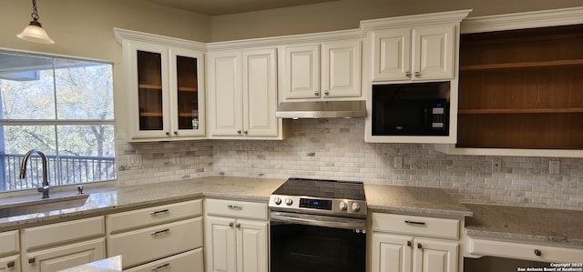 kitchen featuring white cabinetry, electric range, sink, and black microwave