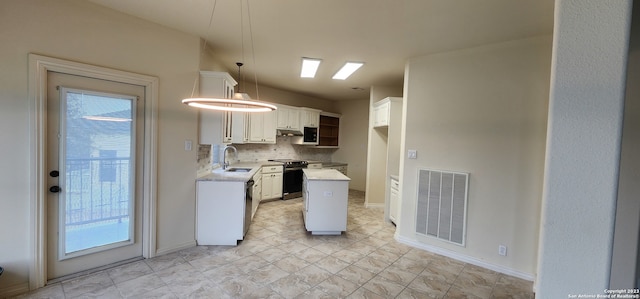 kitchen featuring white cabinetry, hanging light fixtures, decorative backsplash, a center island, and electric range oven