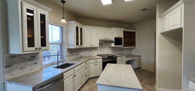 kitchen with white cabinets, sink, light tile patterned floors, decorative backsplash, and electric range