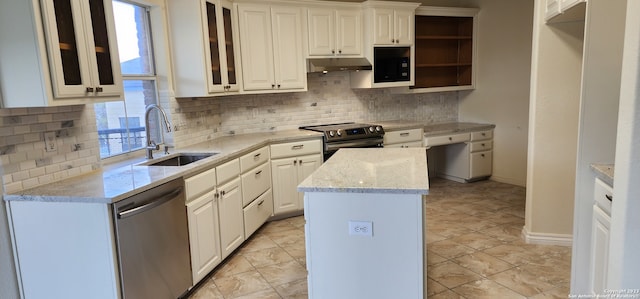 kitchen with white cabinetry, stainless steel appliances, tasteful backsplash, and sink