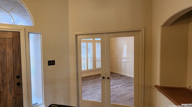 foyer with french doors and hardwood / wood-style floors