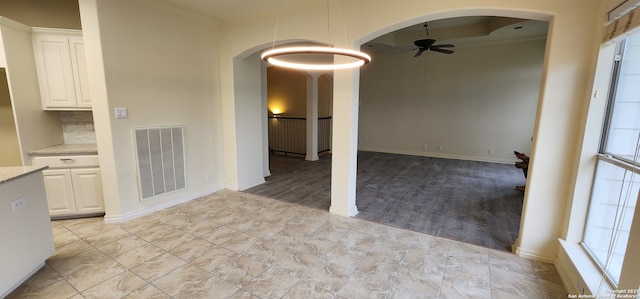 unfurnished dining area with plenty of natural light, light wood-type flooring, and ceiling fan