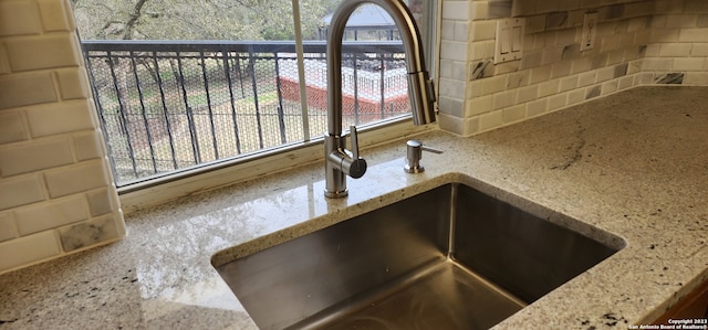 room details featuring sink and light stone counters