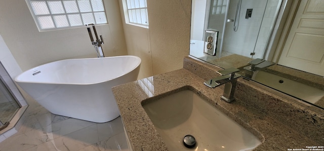 bathroom with shower with separate bathtub, vanity, tile patterned flooring, and a healthy amount of sunlight