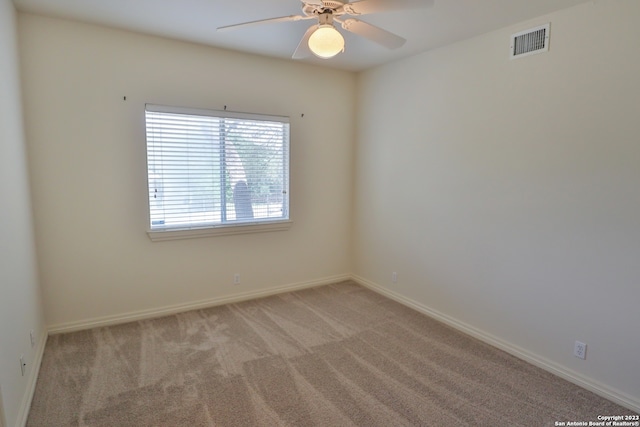 unfurnished room with carpet and ceiling fan