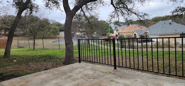 view of gate with a lawn