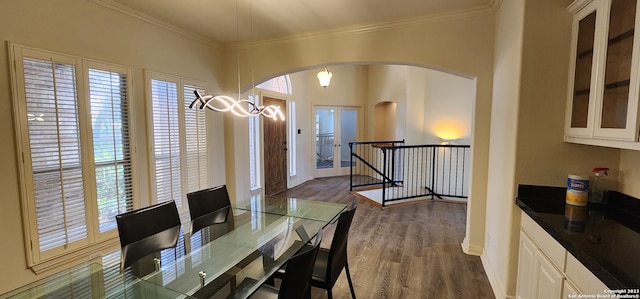 dining room with ornamental molding and dark wood-type flooring