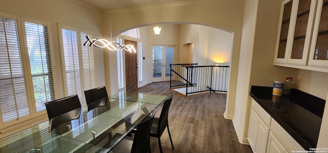 dining room featuring dark wood-type flooring and crown molding