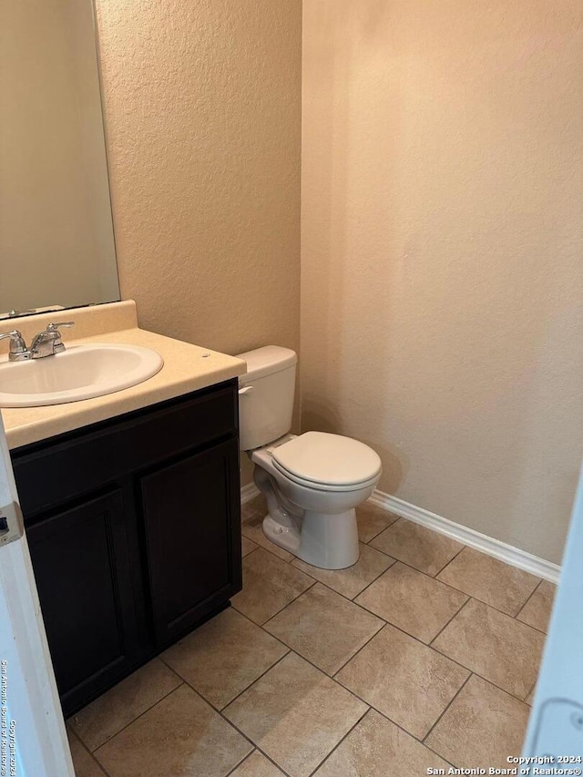 bathroom with tile patterned floors, vanity, and toilet