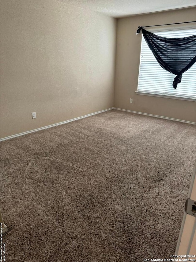 empty room with carpet flooring