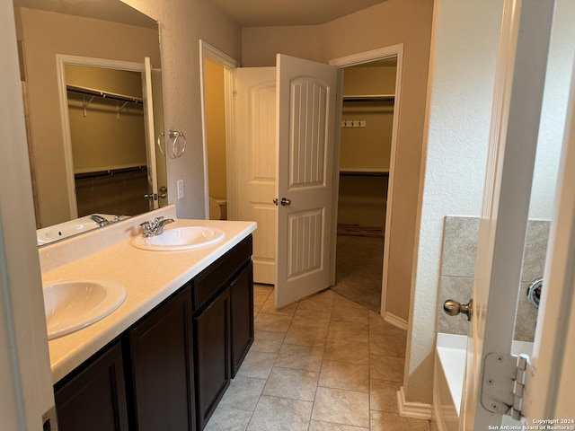 bathroom featuring a bath, vanity, and tile patterned floors