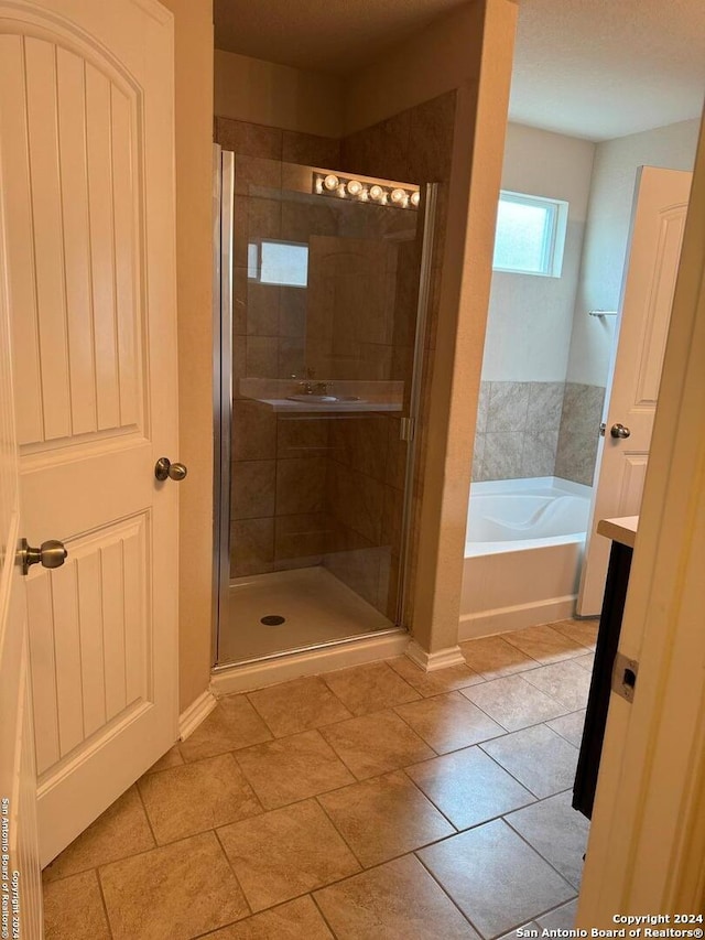 bathroom with tile patterned floors and plus walk in shower