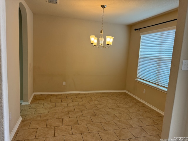 empty room with a notable chandelier