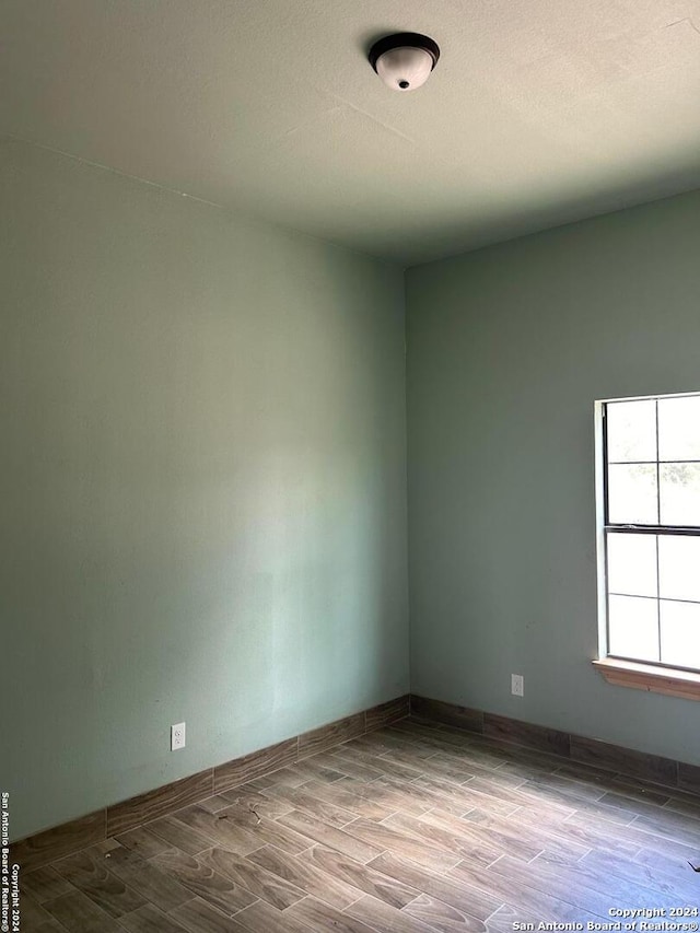 empty room with hardwood / wood-style floors