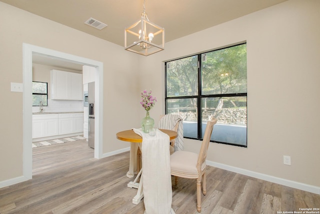 dining space featuring a chandelier and light hardwood / wood-style floors