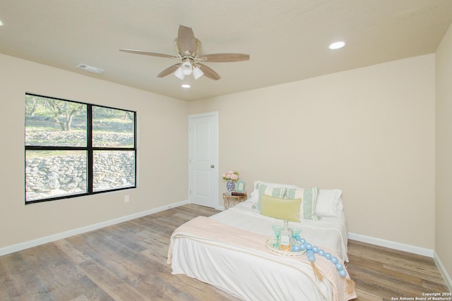 bedroom featuring light hardwood / wood-style flooring and ceiling fan