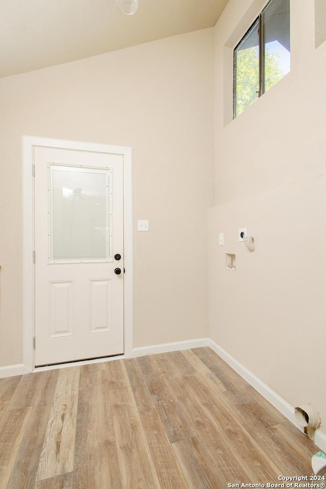 clothes washing area with hookup for a washing machine, light hardwood / wood-style floors, and electric dryer hookup