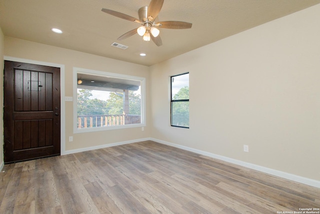 foyer featuring ceiling fan and light hardwood / wood-style flooring