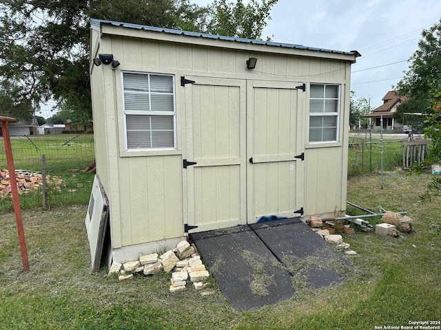 view of outbuilding featuring a lawn