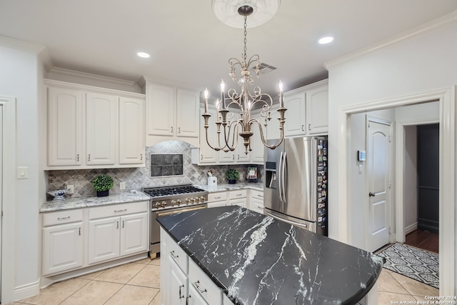 kitchen with light tile patterned floors, a center island, pendant lighting, and stainless steel appliances