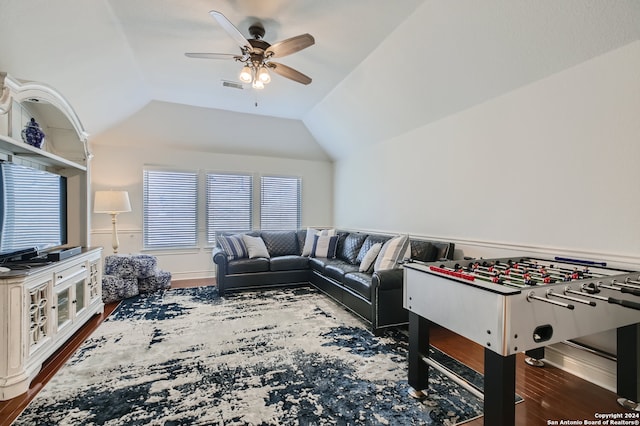 game room with hardwood / wood-style flooring, vaulted ceiling, and ceiling fan