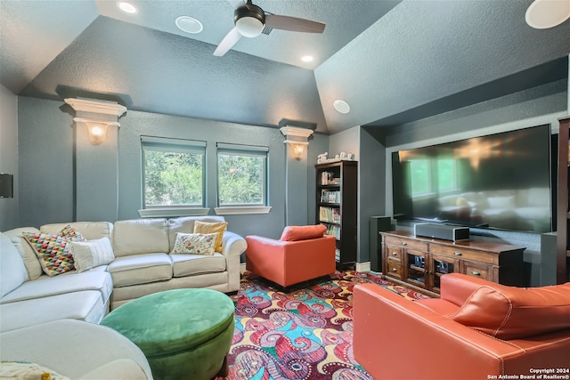 carpeted living room with lofted ceiling, a textured ceiling, ceiling fan, and ornate columns