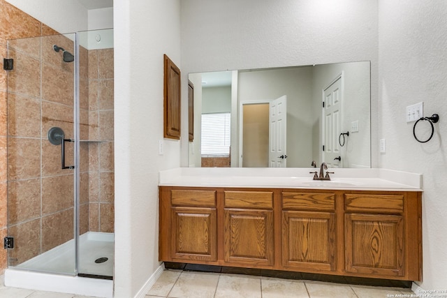 bathroom featuring vanity, tile patterned floors, and a shower with shower door