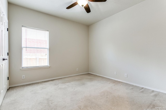 carpeted empty room featuring ceiling fan