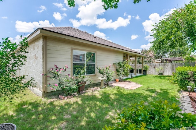 rear view of property with a lawn